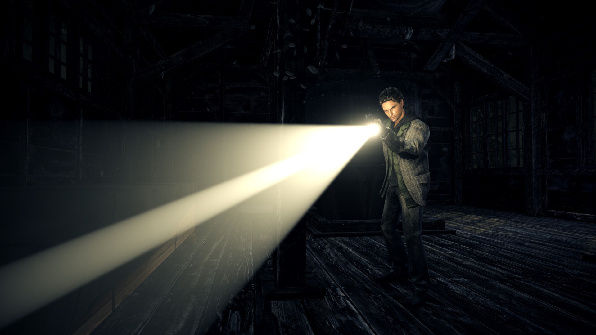 Alan Wake aims a bright flashlight inside a dark wooden building in official original-game PC imagery.