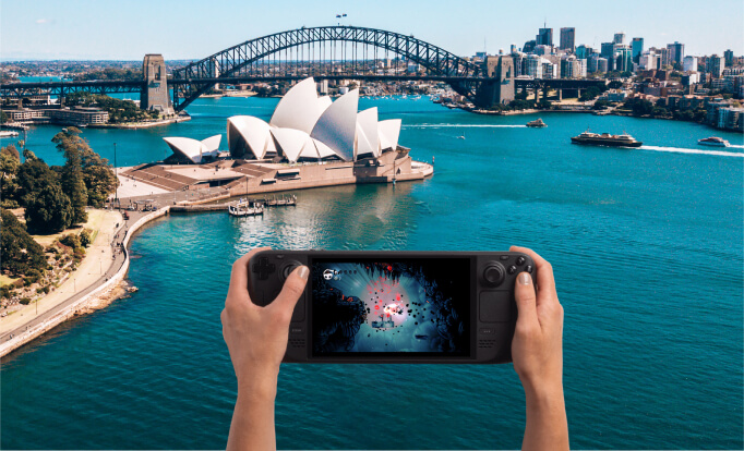 Valve promotional image of hands holding a Steam Deck with Sydney Harbour in the background.